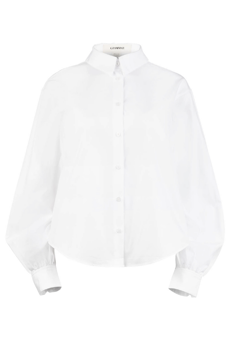 The poet blouse has a standard shirt collar and a dropped shoulder, creating a boxy fit.
