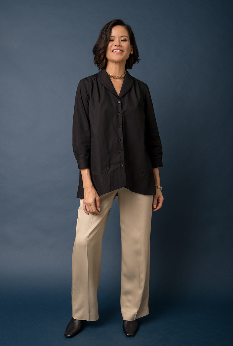The tunic top has buttons that run down the center and has a shawl collar. 