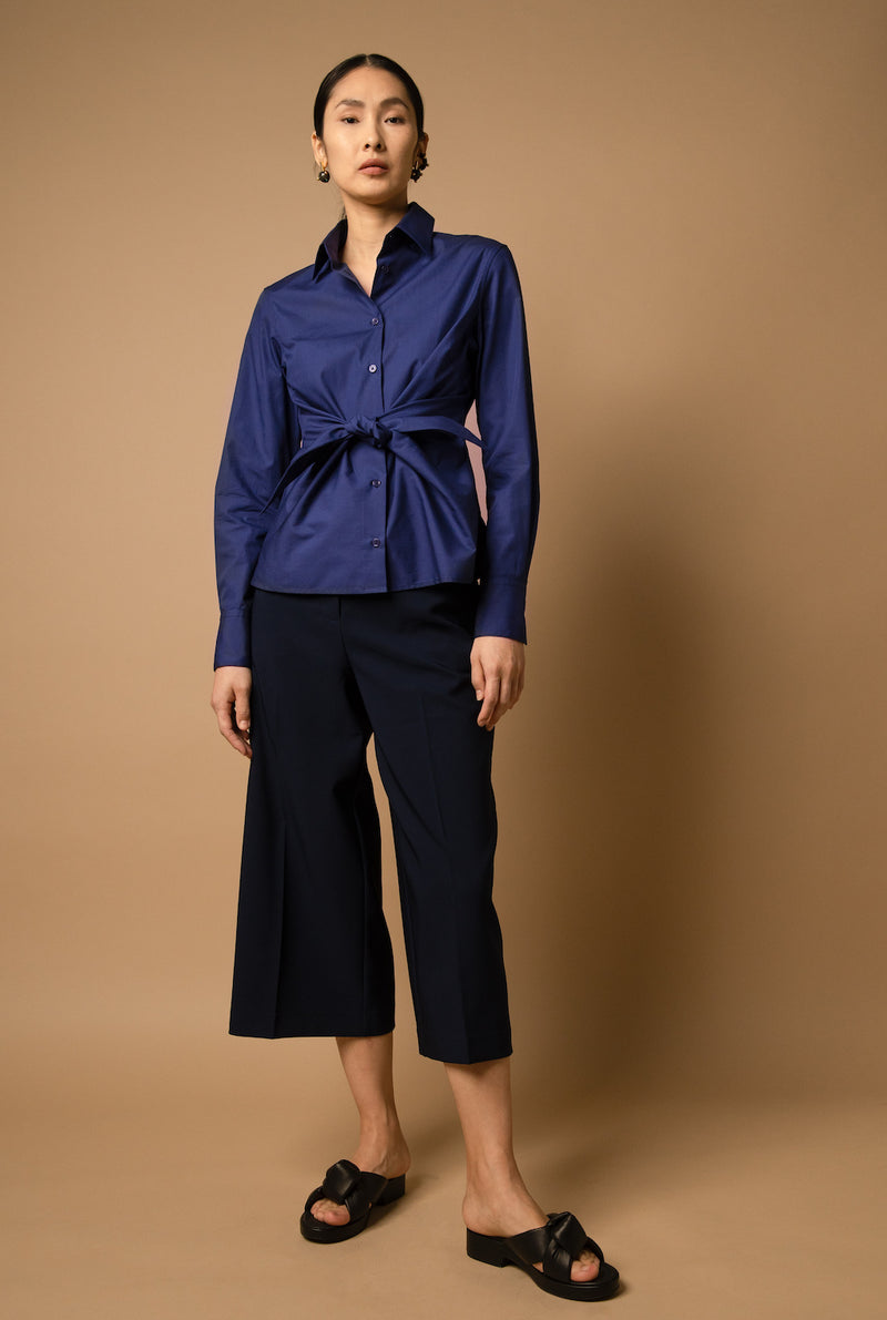 The button-up tie-front shirt comes in dark blue.