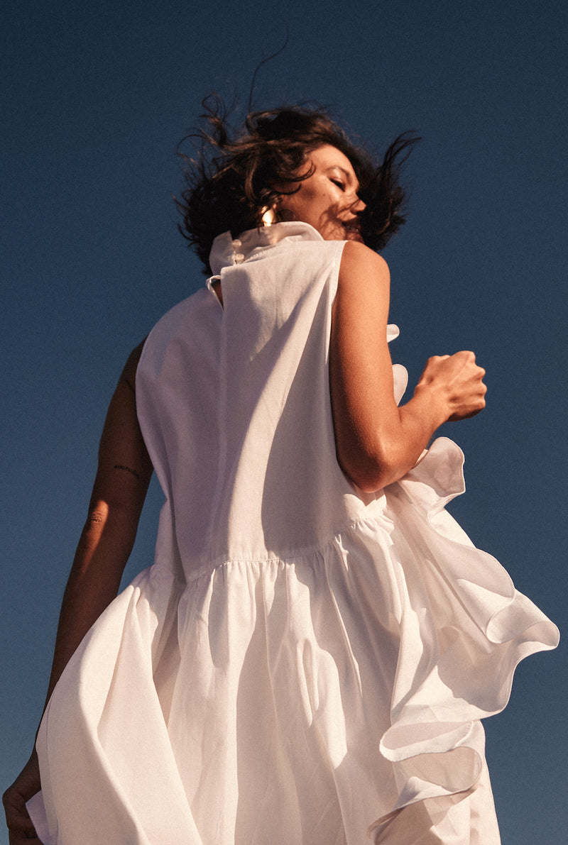 The back of the ruffle dress has two equal-length layers: one that makes the ruffles meet at the lower back and the other is the base of the dress.