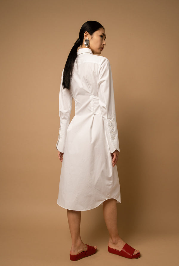 The poplin knee-length shirt dress features extra-long cuffs that have button fixtures.