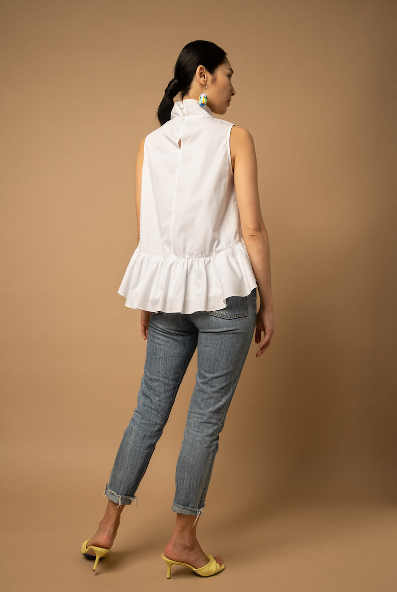 The peplum detailing comes from the ruffles at the front of the shirt that flows down on either side of the body and meets behind the waist.