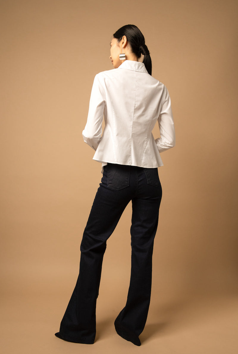 It is slightly fitted at the waist and flares out in a slight peplum detail at the back.